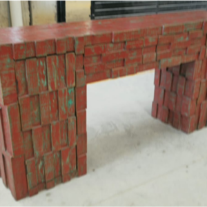 Aztec Brick Console Table with textured brick-style base and distressed red finish